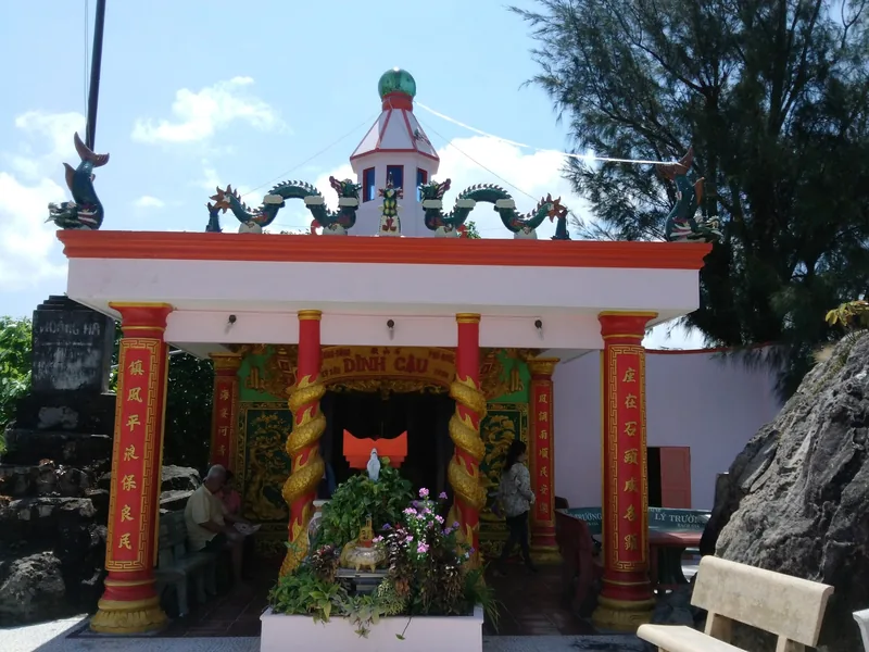 Dinh Cau shrine on Phu Quoc island, with red dragon columns and a domed rooftop shrine.
