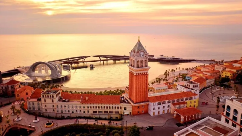 Aerial sunset view of Sun World's Venice-style clock tower and arched bridge in Phu Quoc's Sunset Town